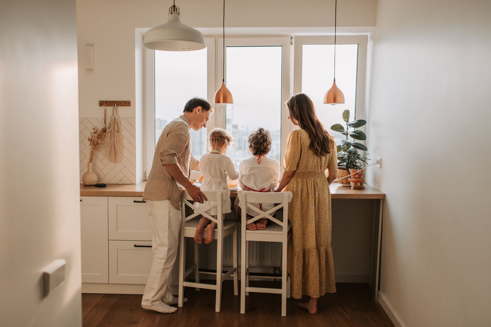 Family spending time together in a cozy kitchen, learning together